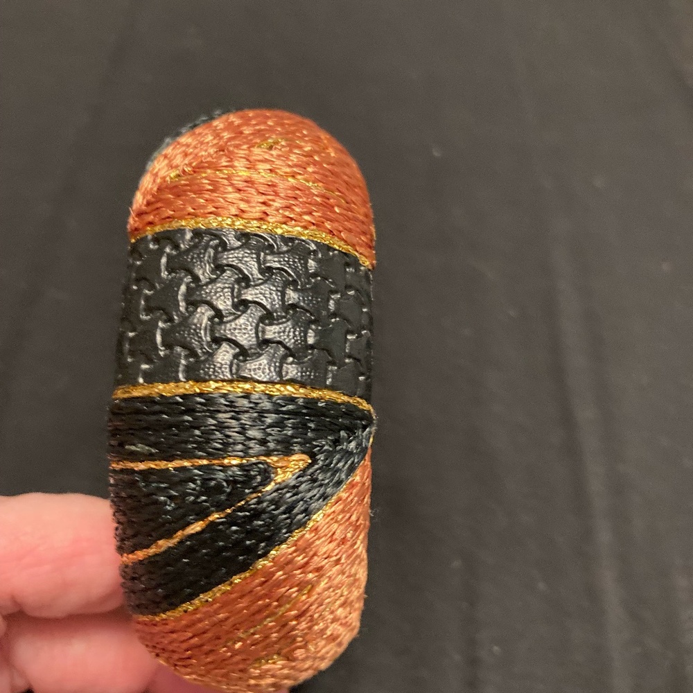Woven black and rust colored wide bracelet. Beautiful designs.